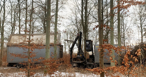 På lastbilshuggen finns en grip som föraren samlar upp grot med. Med gripens last förs det vidare till en maskin som maler ner det till flis som hälls direkt i en ”låda” på lastbilen.